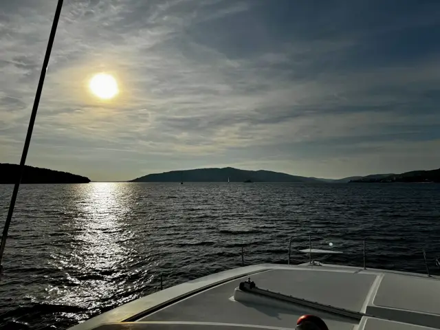 Tiefstehende Sonne über dem Wasser, vom Vorschiff aus